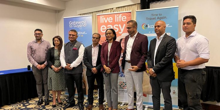 Minister of Tourism, Industry and Commerce - Hon. Oneidge Walrond (4th from right) & Mr. Salaudeen Nausrudeen (4th from left) - Founder/CEO of Kaietour.com pose for a photo opp with tourism, Government and private sector leaders who were present at the launch.