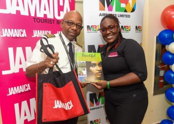 Pictured: Acting Visitor Relations Manager, Jamaica Tourist Board, Candessa Cassanova presents Captain Leon Missick with gifts following the flight’s arrival into Sangster International Airport.