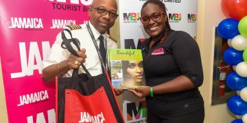 Pictured: Acting Visitor Relations Manager, Jamaica Tourist Board, Candessa Cassanova presents Captain Leon Missick with gifts following the flight’s arrival into Sangster International Airport.