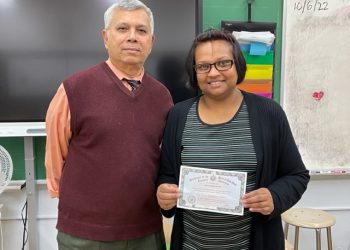 A happy Devi with her GED diploma