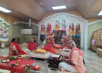Pandit Vigyan and devotees perform puja