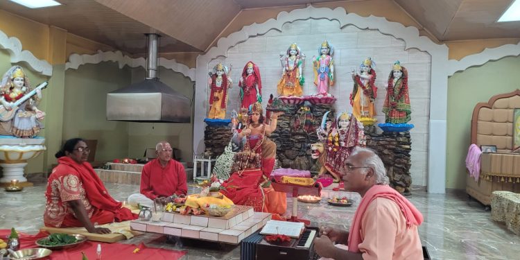 Pandit Vigyan and devotees perform puja
