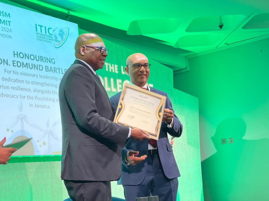 Pictured: Minister of Tourism, Hon. Edmund Bartlett (L) collects his ITIC award for his work in Sustainability and Resilience in Tourism at the ITIC Global Tourism Summit on Monday, November 4, from Ibrahim Ayoub, Group CEO, MD and Board Member of International Tourism Investment Corporation Ltd.