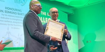 Pictured: Minister of Tourism, Hon. Edmund Bartlett (L) collects his ITIC award for his work in Sustainability and Resilience in Tourism at the ITIC Global Tourism Summit on Monday, November 4, from Ibrahim Ayoub, Group CEO, MD and Board Member of International Tourism Investment Corporation Ltd.