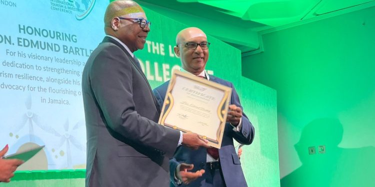 Pictured: Minister of Tourism, Hon. Edmund Bartlett (L) collects his ITIC award for his work in Sustainability and Resilience in Tourism at the ITIC Global Tourism Summit on Monday, November 4, from Ibrahim Ayoub, Group CEO, MD and Board Member of International Tourism Investment Corporation Ltd.