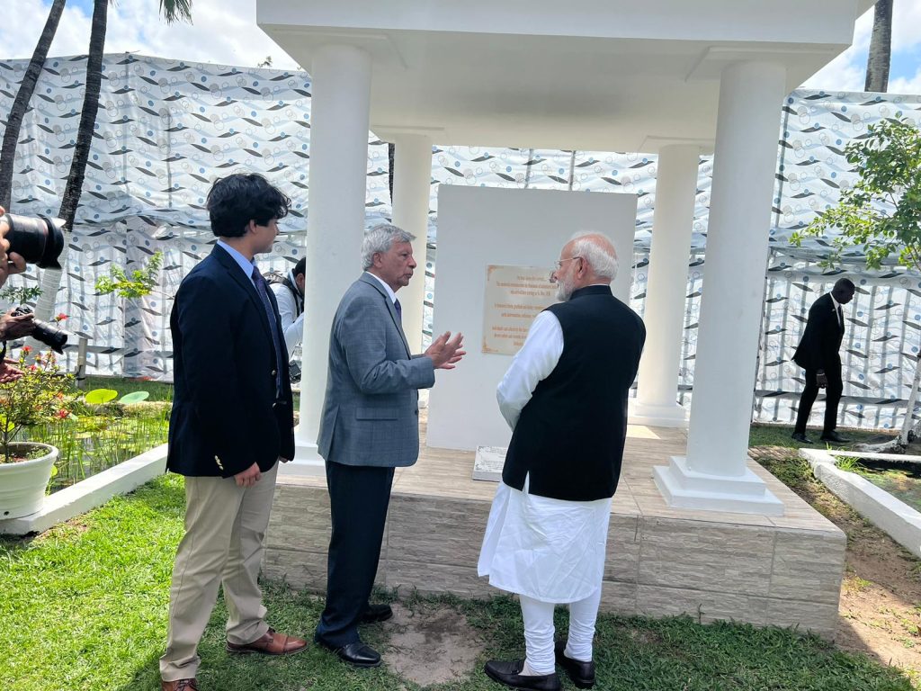 Ashook Ramsaran discussing the significance of the Indian Arrival Monument to Indian PM Modi while grandson Jaden Ramsaran observes. November 21, 2024 at Monument Gardens in Georgetown, Guyana.. 