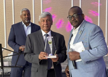 Ashook Ramsaran (center) with award to Dr. David Dabydeen presented by Queens College Alumni Association president John Campbell (right). Event moderator Roberts on the left.